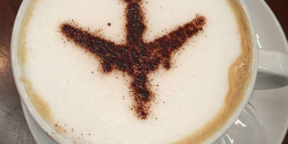 Cup of coffee with plane art