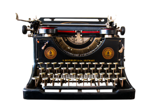A photograph of a manual typewriter. Image by Gerhard G. on Pixabay.