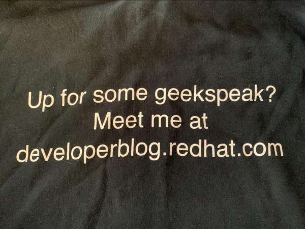 A jacket with text on the back: "Up for some geekspeak? Meet me at developerblog.redhat.com."