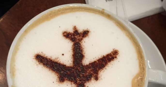Cup of coffee with plane art