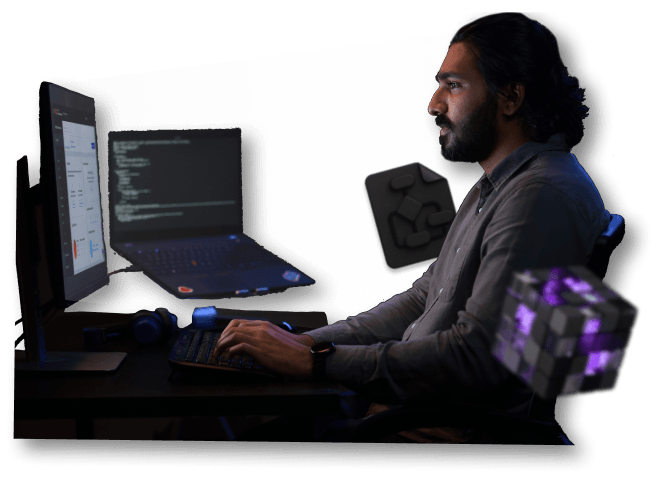 a man sitting in front of a computer screen with his hands on the keyboard